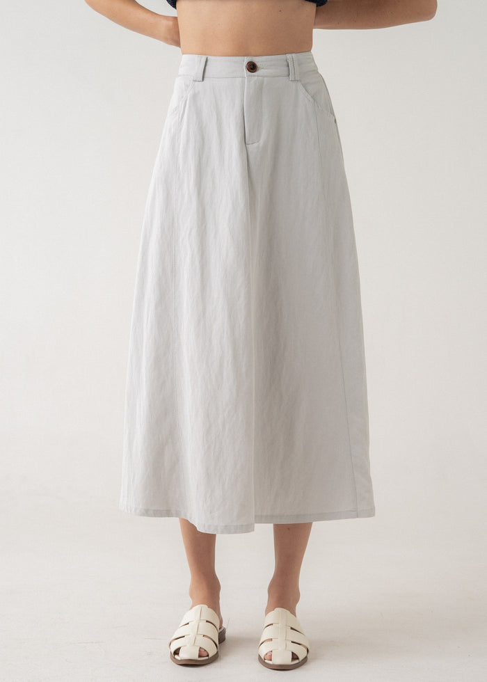 White linen a-line midi skirt with front pleats and button waistband.
