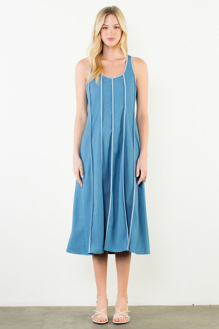 Blue sleeveless denim dress with vertical seaming detail and A-line silhouette, midi length.