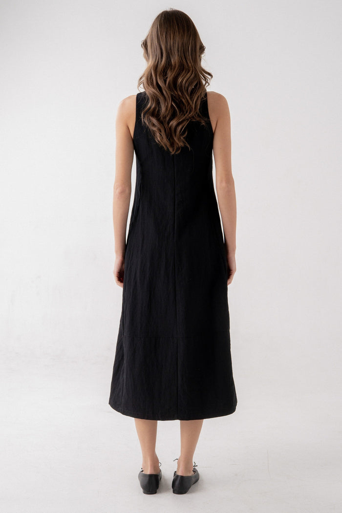 Black sleeveless midi dress with A-line silhouette, shown from back view on model.