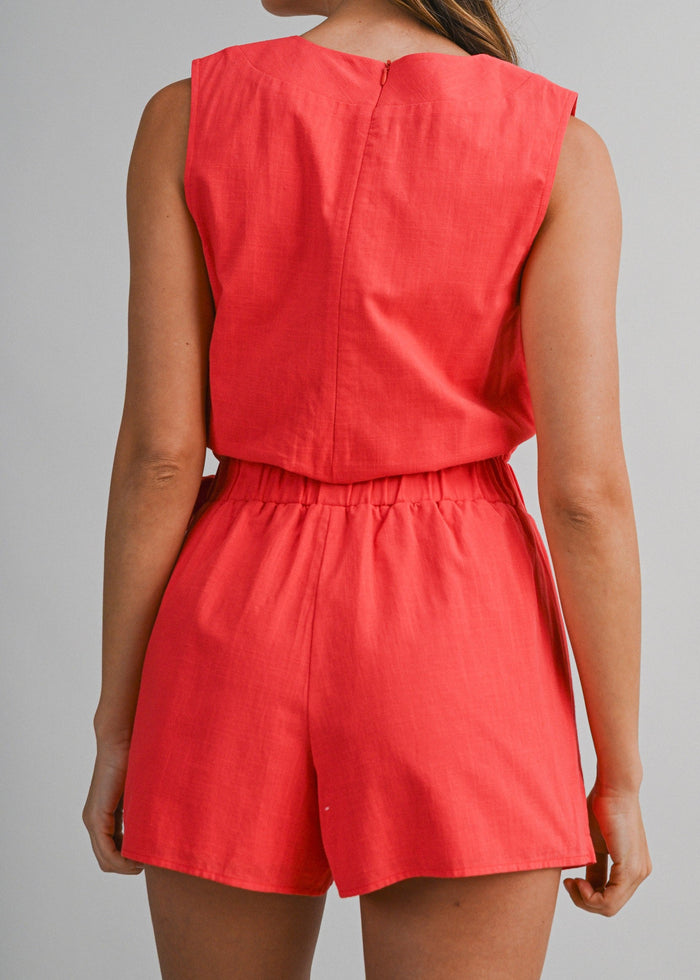 Red sleeveless V-neck romper with elastic waist and shorts-style legs, shown from back view.