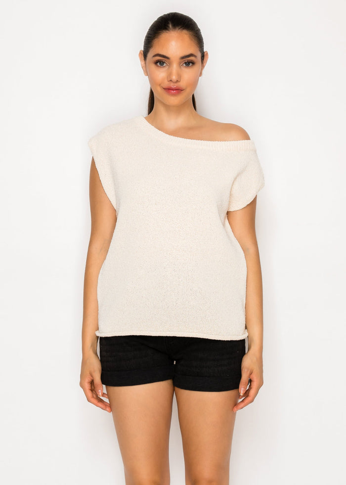 Cream textured one-shoulder top with short sleeves and asymmetrical neckline.