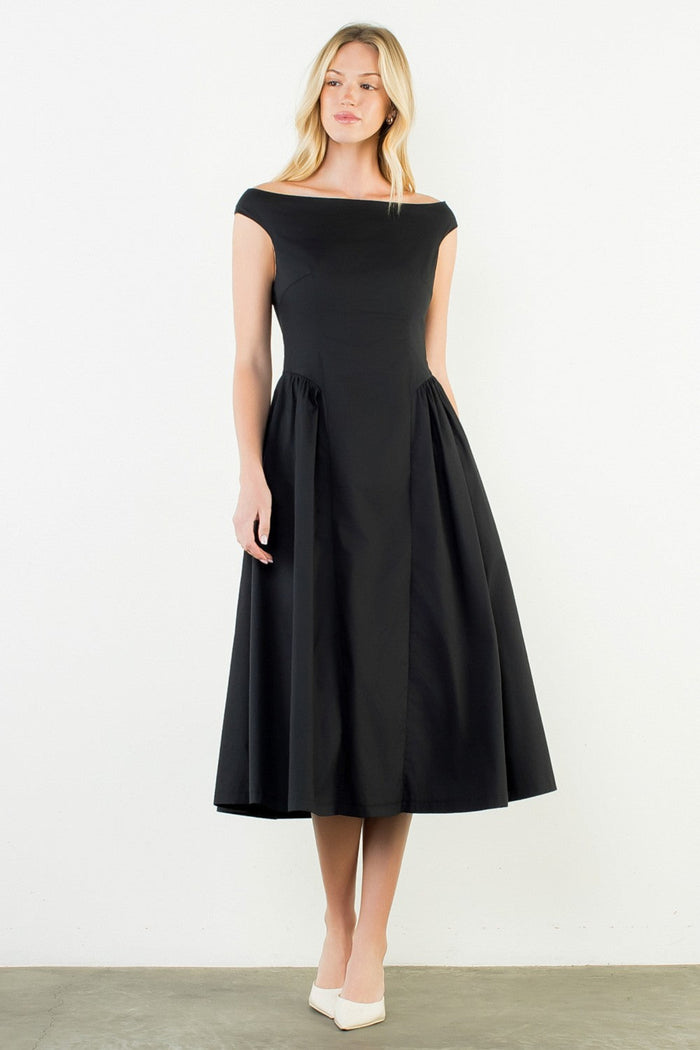 Woman wearing a black off-shoulder dress on a white background