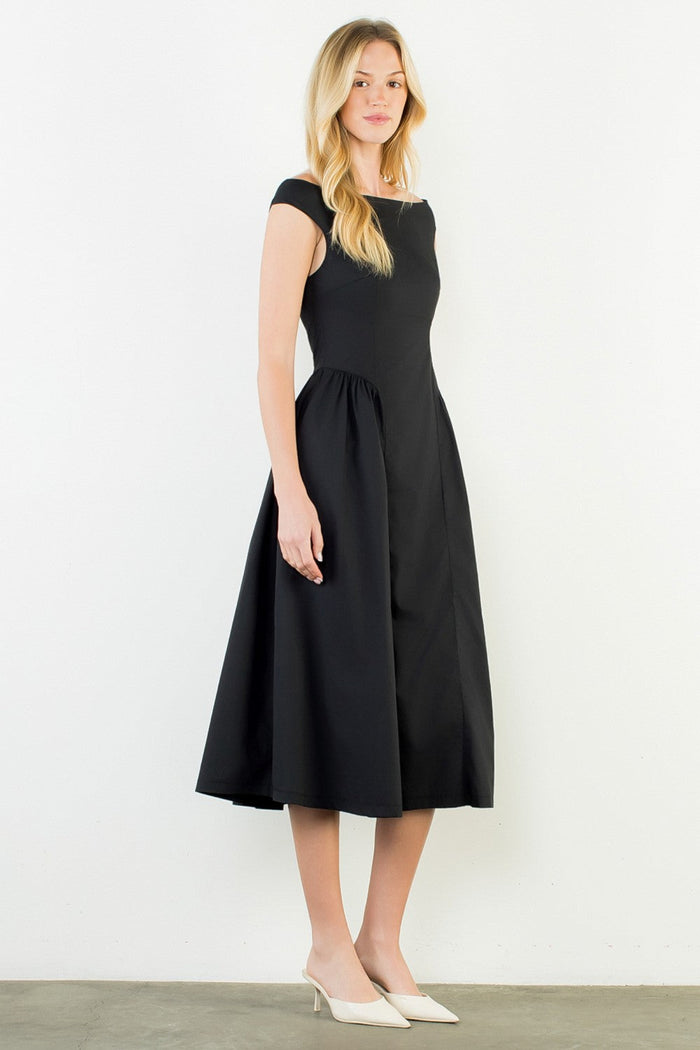Woman wearing a black dress against a white background