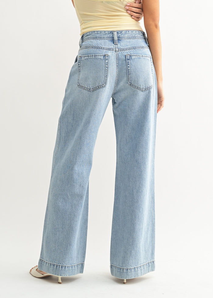 Light wash denim jeans with relaxed fit, high waist, and wide leg, shown from back view.