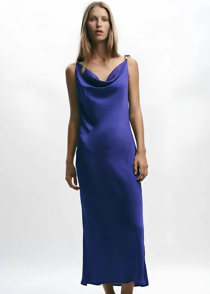 Royal blue slip dress with cowl neckline and thin shoulder straps on model.
