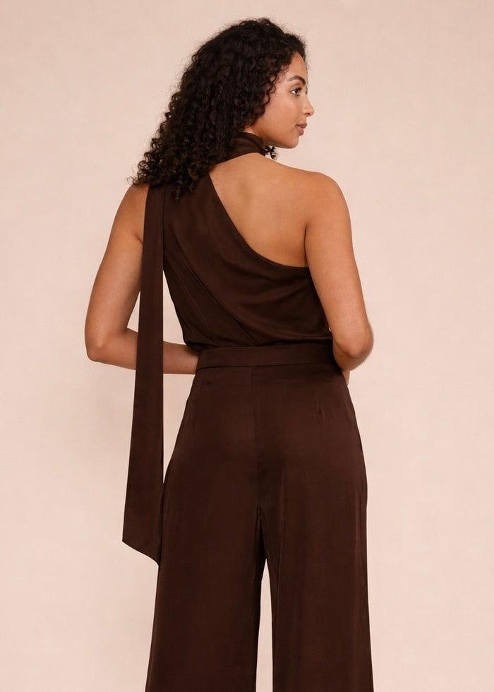 Brown one-shoulder top with draped fabric detail, shown from back view on model.