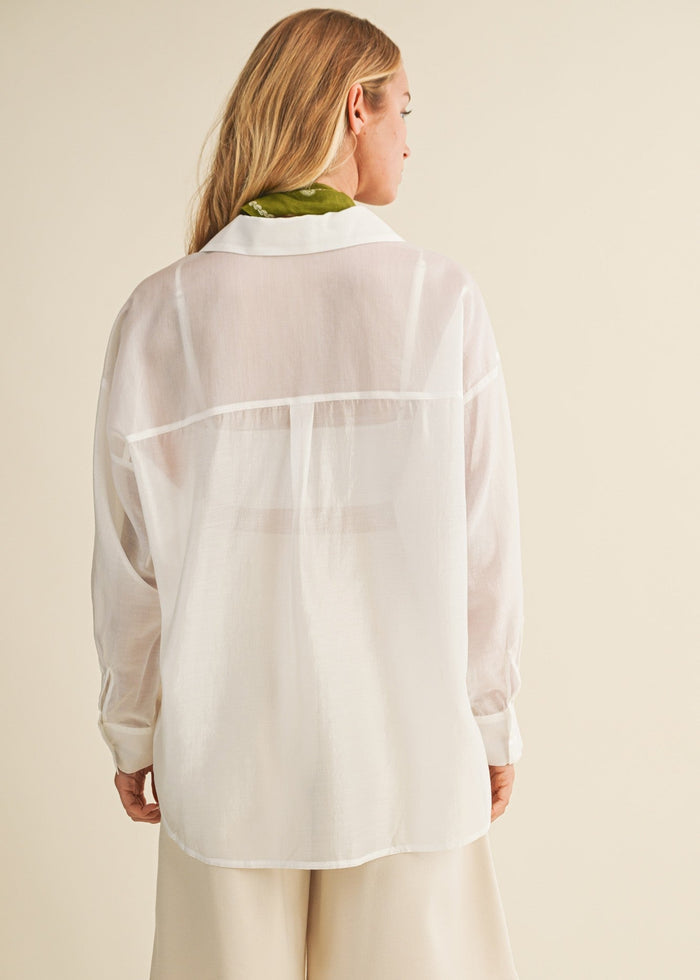 White linen button-down shirt with collared neckline and long sleeves, worn by model shown from back view.