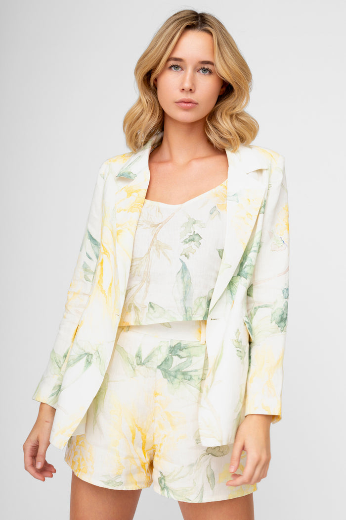 Cream shorts with yellow and green watercolor floral print, shown with matching blazer.