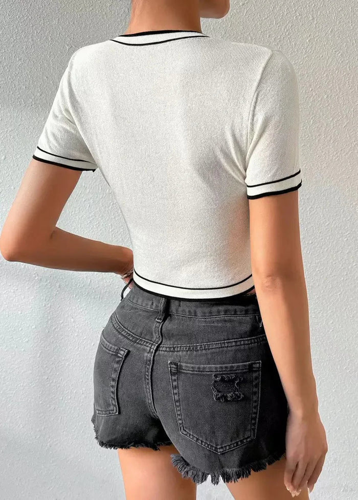 White ribbed short sleeve top with black and white striped trim at neckline, sleeves and hem.