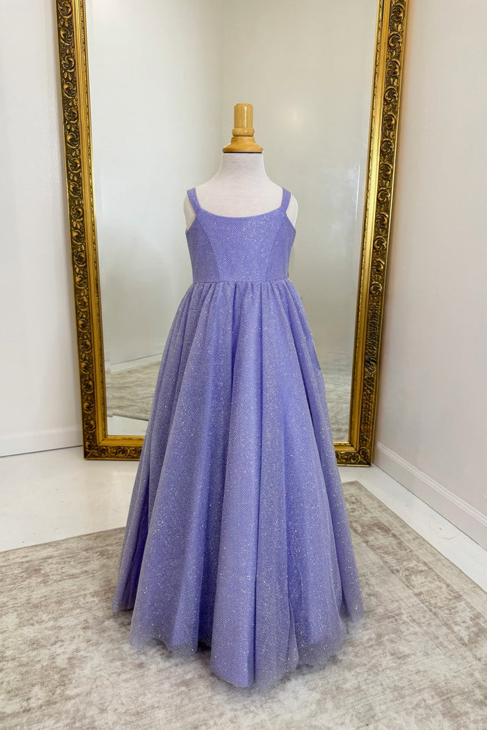 A lavender purple sleeveless A-line dress with a textured bodice and a full tulle skirt, displayed on a mannequin in front of a large gold-framed mirror.