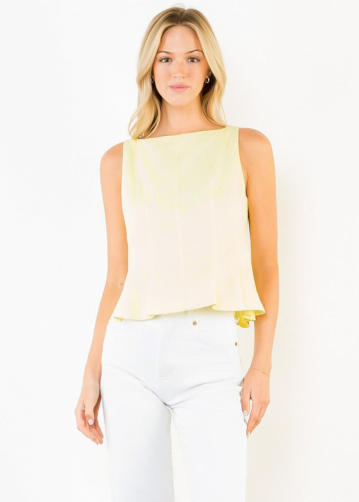 Light yellow sleeveless peplum top with ruched hem detail, worn with white pants.