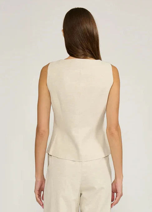 Cream sleeveless vest top with crew neckline, shown from back on model.