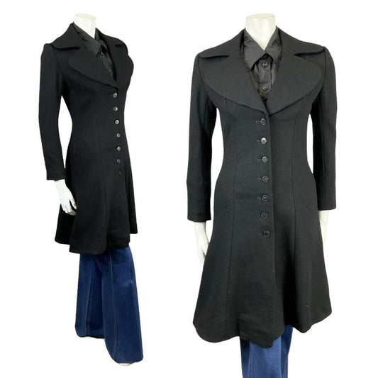 Shrinking Violets Vintage Aidma mod black long coat on a mannequin wearing blue flared jeans