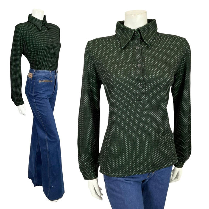 Mannequin wears a black and green polka dot dagger collar 60s 70s shirt with blue flared jeans