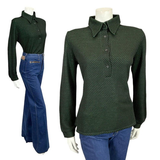 Mannequin wears a black and green polka dot dagger collar 60s 70s shirt with blue flared jeans