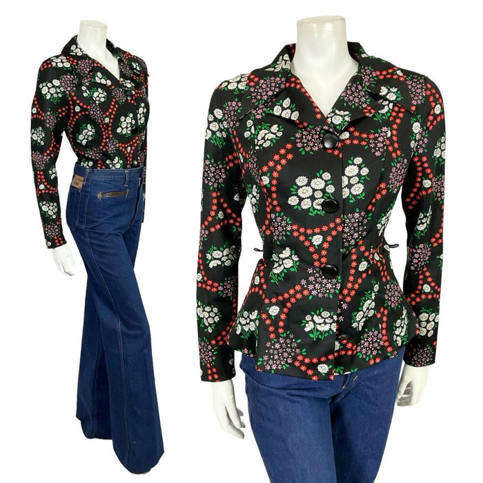 Mannequin wears a 60s 70s black white and red dagger notch lapel shirt with blue flared jeans.