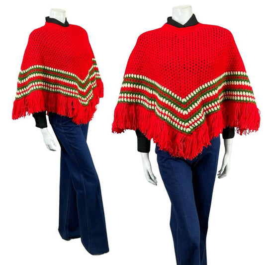 Shrinking Violets vintage 60s 70s bight red, white and green chevron knitted poncho on a white mannequin wearing blue flared jeans