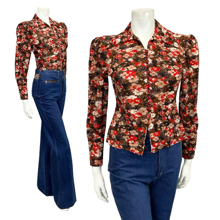 Mannequin wears a blue and red floral printed 60s 70s dagger collar blouse with blue flared jeans