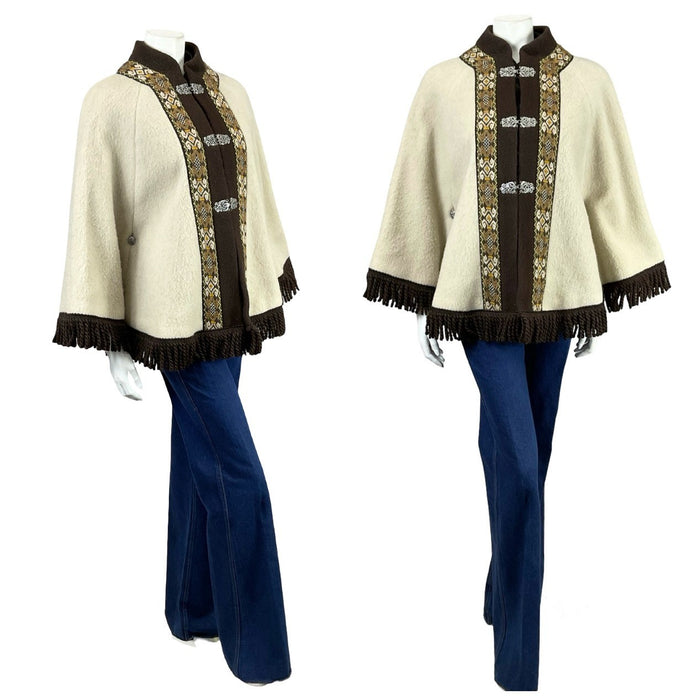 Shrinking Violets vintage cream and brown Icelandic nordic folk trim cape with metal clasps and trim on a mannequin wearing blue flared jeans