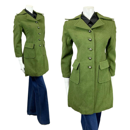Shrinking Violets Vintage 60s 70s mossy green wool mod coat with dagger collar on a white mannequin wearing blue flared jeans