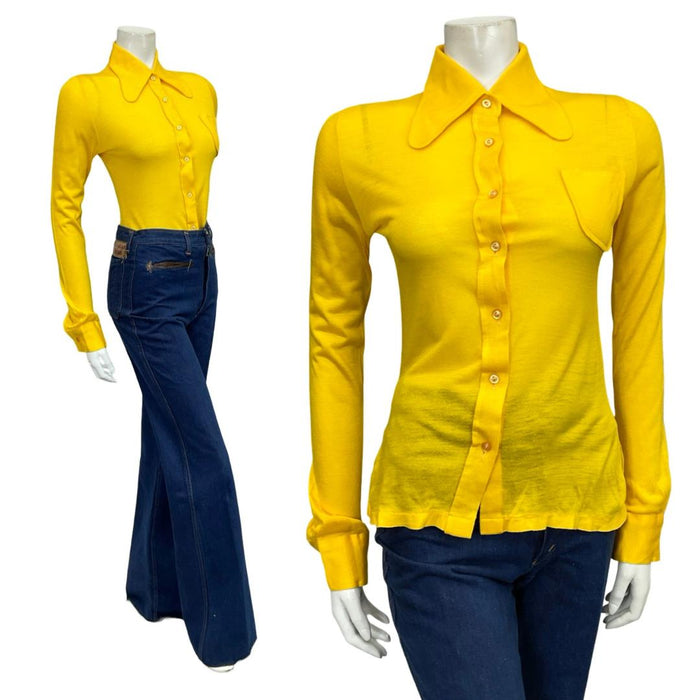 Mannequin wears a 60s 70s bright yellow mod dog ear collar shirt with blue flared jeans