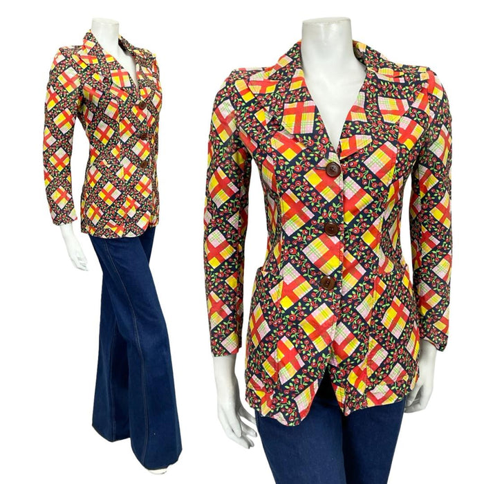 Shrinking Violets Vintage 60s 70s red blue and yellow plaid floral blazer style shirt on a white mannequin wearing blue flared jeans