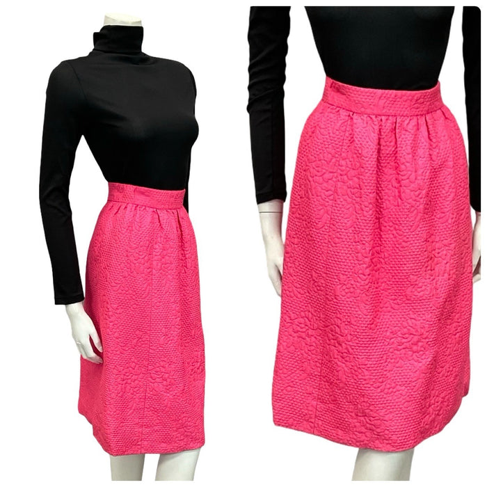 Shrinking Violets Vintage 60s 70s bright hot pink mod mini skirt with floral embossing on a white mannequin wearing a black turtleneck