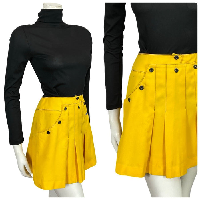 Mannequin wear a bright yellow 60s mod sailor pleated mini skirt with navy blue contrast stitching and a black turtleneck