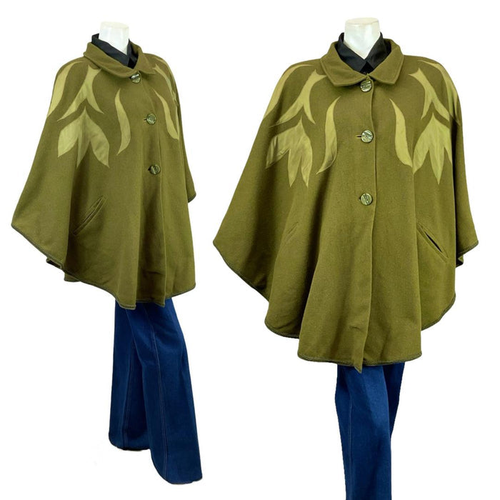Shrinking Violets Vintage 60s 70s olive green psychedelic applique wool cape on a mannequin wearing blue flared jeans