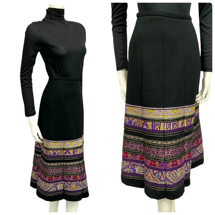 Mannequin wears a 70s black and purple folk ribbon trim quilted midi skirt with a black turtleneck.