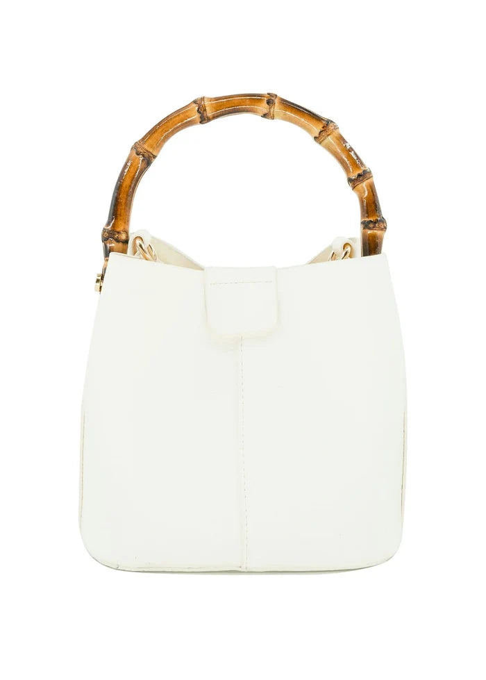White bucket handbag with bamboo handles and front flap closure.