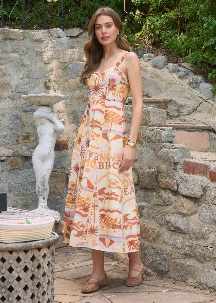 Sleeveless midi dress with orange and cream geometric print and adjustable shoulder straps.